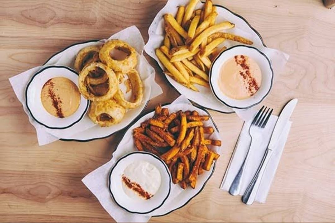 Delicious Fries and Onion Rings with Dipping Sauces at Black Tap Craft Burgers and Beer Dallas